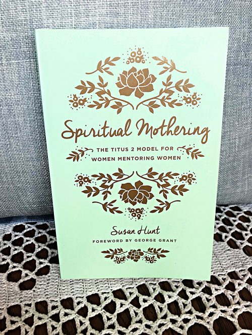 green spiritual mothering book with a white and blue backdrop