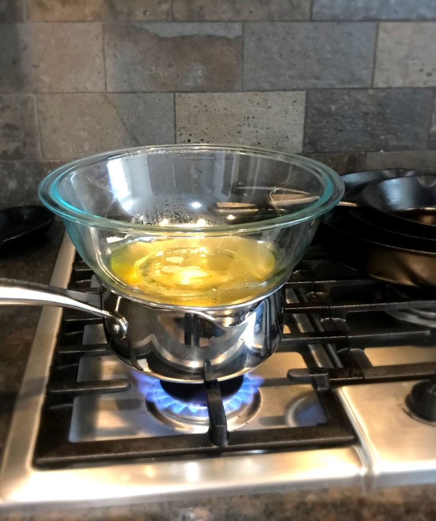 Makeshift DIY double broiler melting oil and butter for a homemade body butter recipe