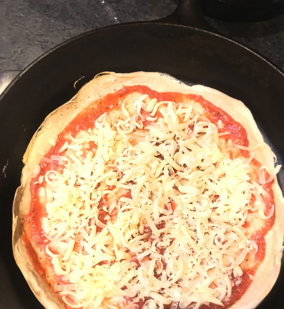 Shredded mozzarella cheese on a pizza