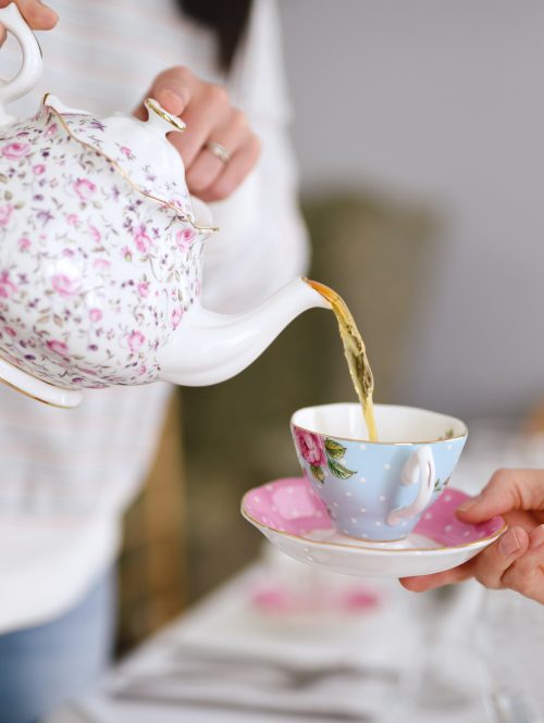 Woman pouring tea into a tea cup
