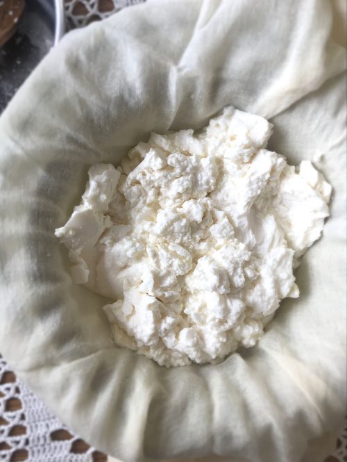 Homemade cream cheese curds in a butter muslin