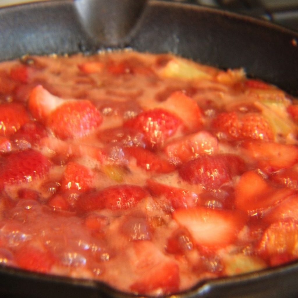 Strawberries and Rhubarb simmering on a stove top