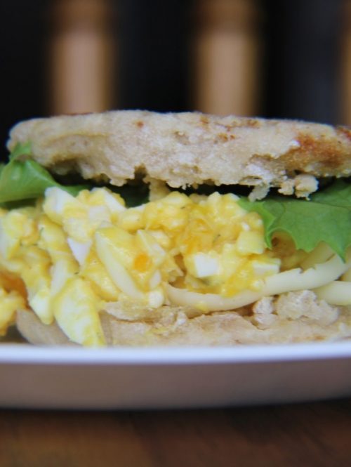 homemade egg salad sandwich on an english muffin with lettuce