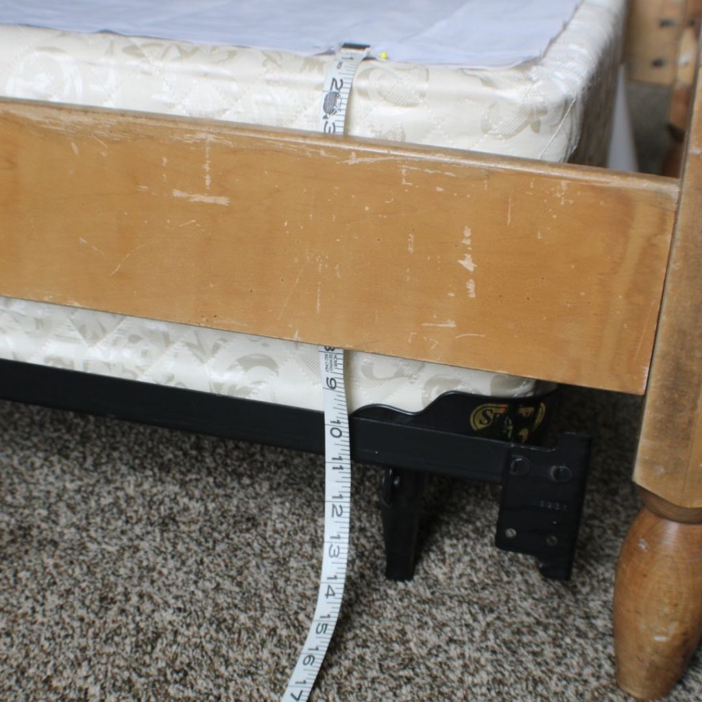Tape measure showing distance from base material on bed to the floor for a bedskirt