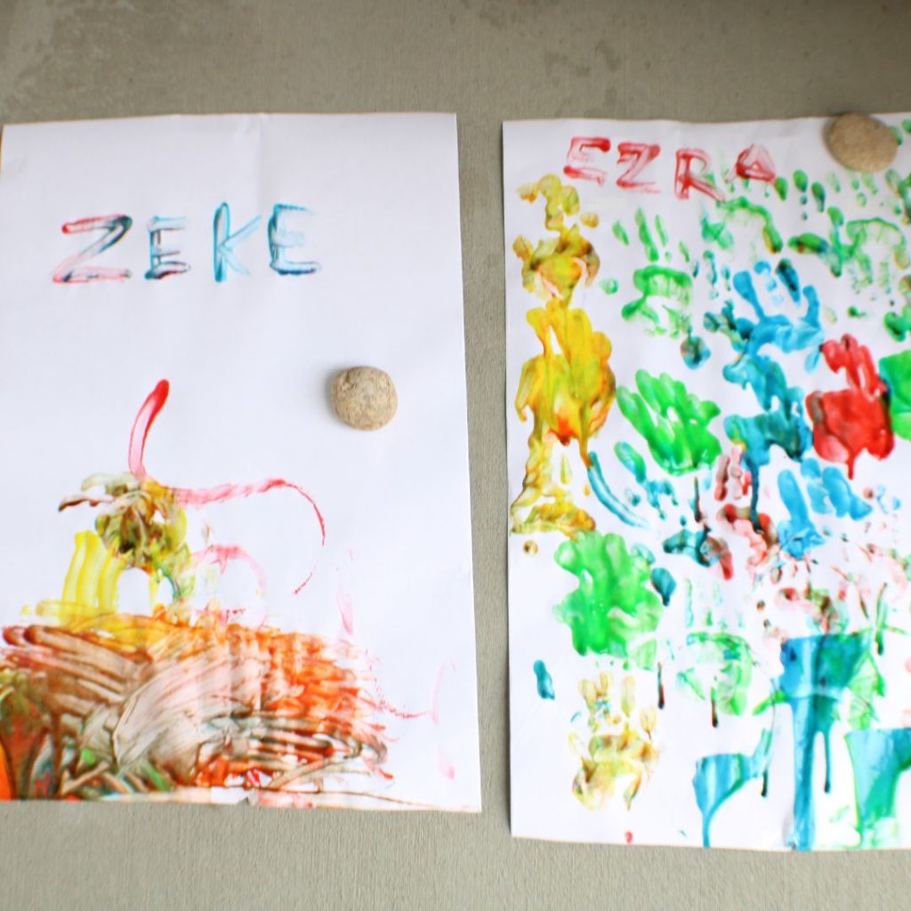 Two pieces of paper with finger paint on them 