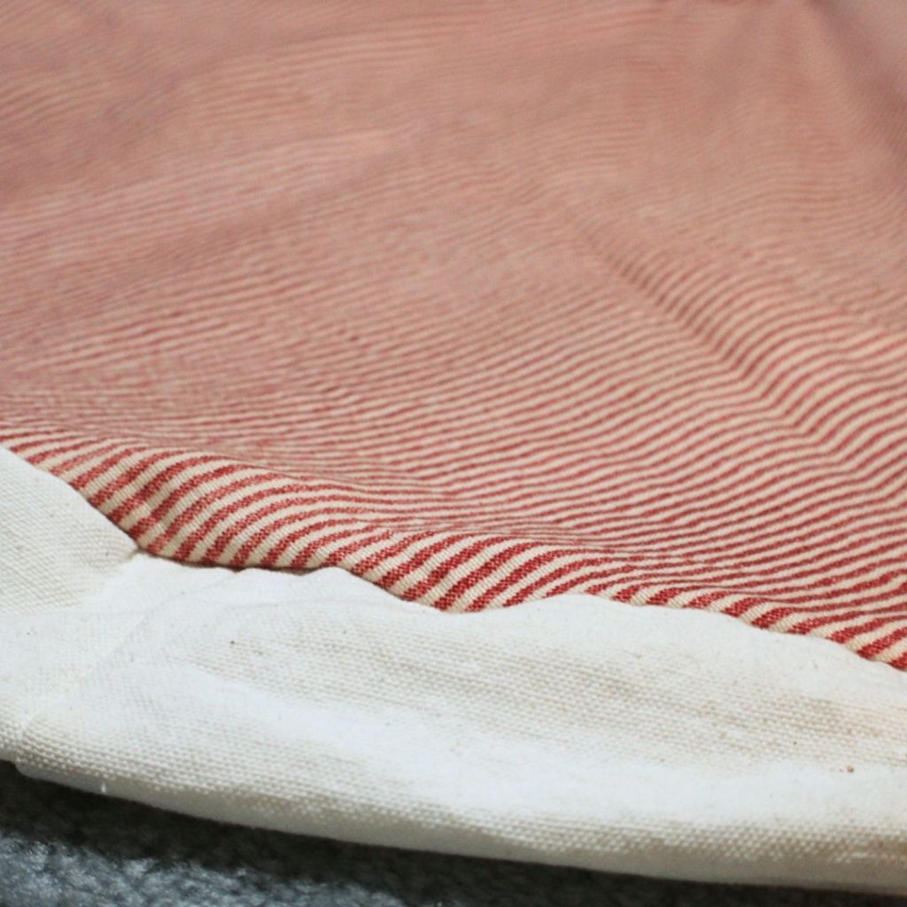 White edge of a tree skirt with red stripes